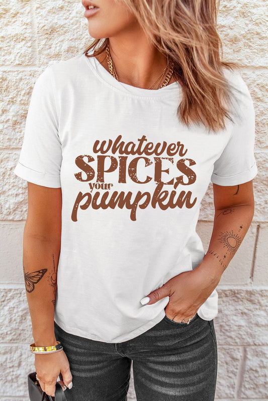 A woman wears a white graphic tee that says "WHATEVER SPICES YOUR PUMPKIN."
