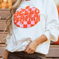 A woman wears a white long-sleeve sweatshirt with a "Hello Pumpkin" patch.