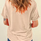 A woman from behind wears a light beige t-shirt and blue jeans.