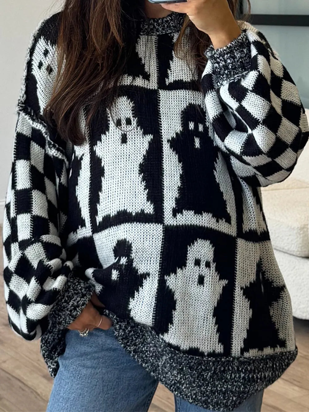 Black and white ghost and checkerboard pattern dropped shoulder long sleeve sweater.