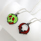 Two Halloween-themed necklaces, one with a green skull and one with a red bat.