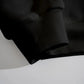 Close-up of a black sweatshirt sleeve and ribbed cuff.