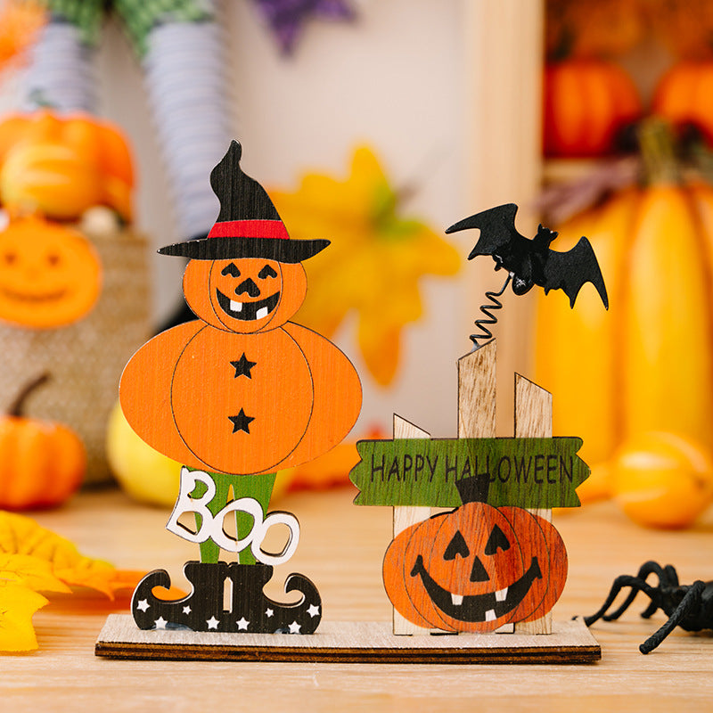 Two wooden Halloween ornaments, one a pumpkin scarecrow and the other a pumpkin with a bat.