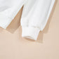 Close-up of a white long-sleeve sweatshirt with ribbed cuffs.