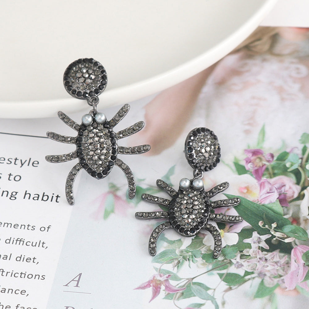 Spider rhinestone alloy earrings with pearl accents.