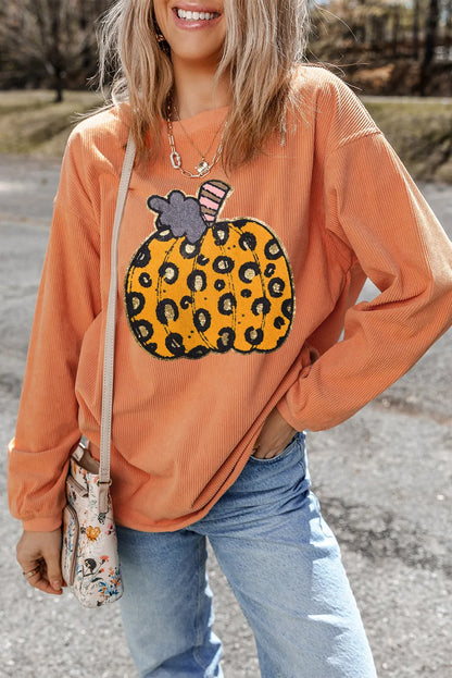 An orange long-sleeve sweatshirt with a leopard print pumpkin design.