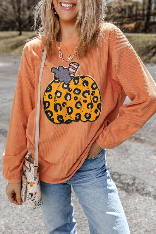 An orange long-sleeve sweatshirt with a leopard print pumpkin design.
