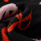 Close-up of a black and orange Halloween pumpkin pattern button-up cardigan.