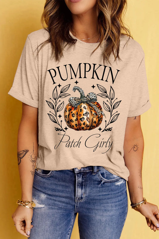 A woman wears a beige short-sleeve t-shirt with a "Pumpkin Patch Girly" graphic.