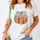 White short sleeve t-shirt with a pumpkin graphic and leopard print bow.