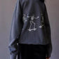 Oversized gray sweatshirt with white skeleton graphics skateboarding.