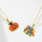 Two Halloween-themed necklaces, one with a pumpkin and one with "Trick or Treat."