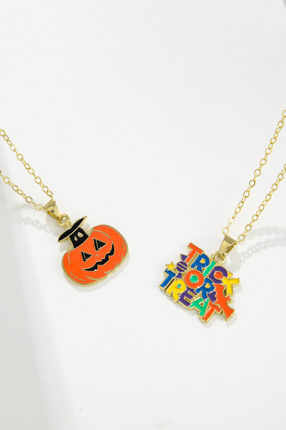 Two Halloween-themed necklaces, one with a pumpkin and one with "Trick or Treat."