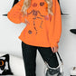 Halloween Skeleton Pumpkin Sweatshirt in orange with sequin details.