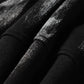 Close-up of a black hoodie with a subtle, shimmering spider web print.
