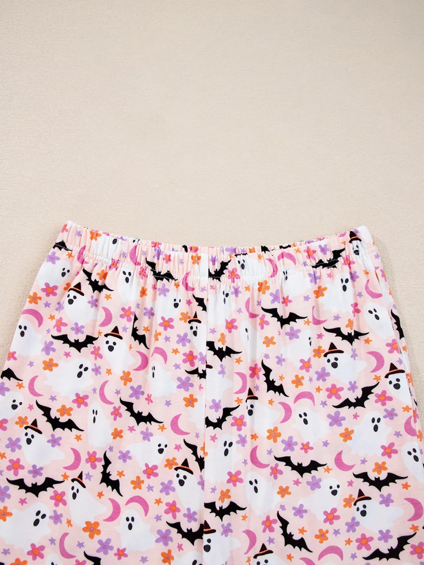Pink Halloween ghost print lounge pants with an elastic waistband.