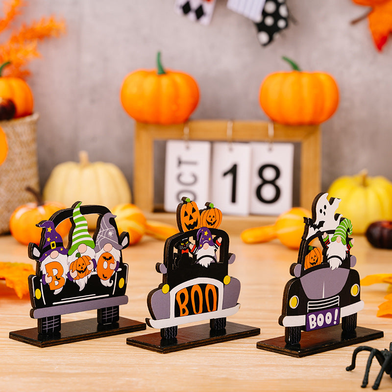 Three car-shaped Halloween ornaments featuring gnomes, pumpkins, and ghosts.