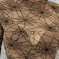 A sheer, long-sleeve blouse with a black spider web print on a tan background.